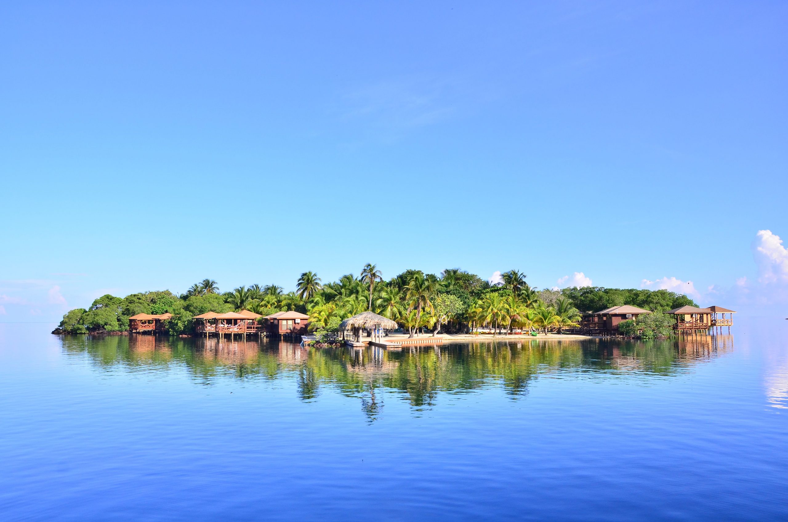 Wide angle view from a boat in the ocean of Anthony's Key Resort shore line in Roatan, Honduras