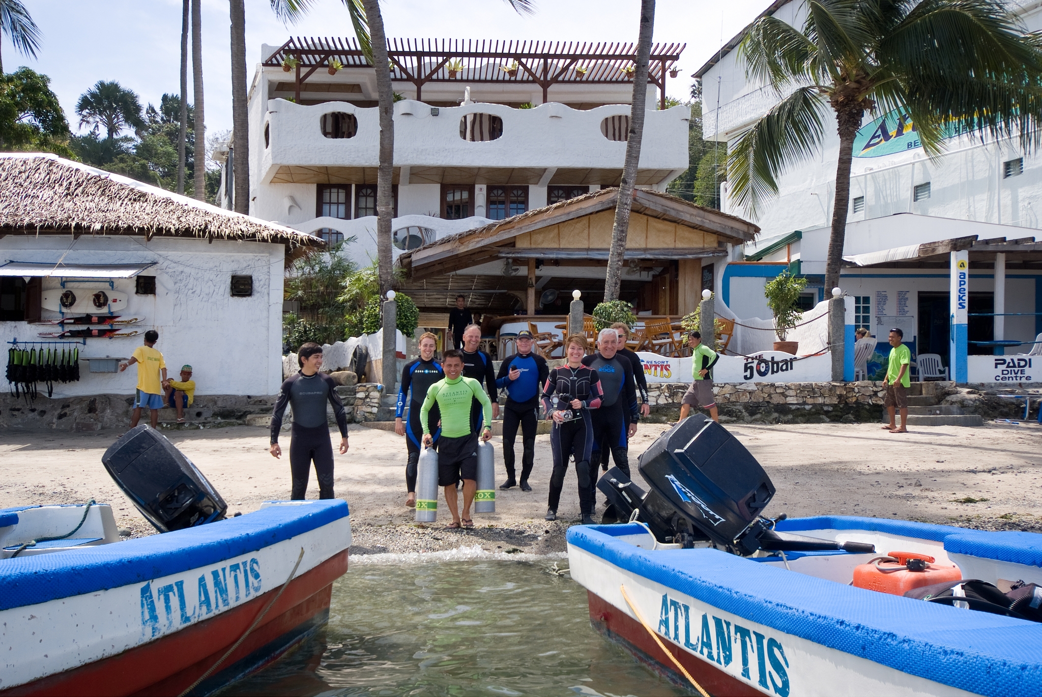 Scuba Divers loading into boats via the shore line at Atlantis Resort Puerto Galera, Philippines