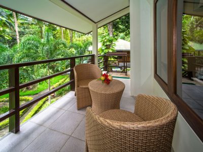 Lembeh Resort POV from Balcony View with two whicker chairs and side table